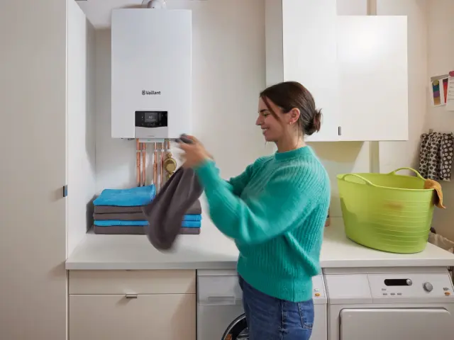 Kvinde folder sit vasketøj sammen